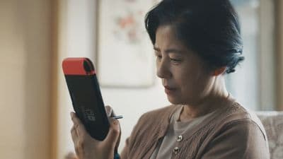 a woman sitting on a couch looking at a cell phone