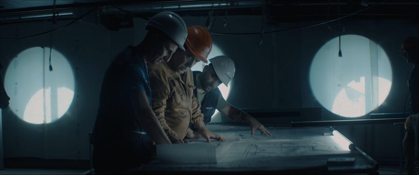 a group of people standing around a table in a room