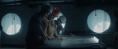 a group of people standing around a table in a room