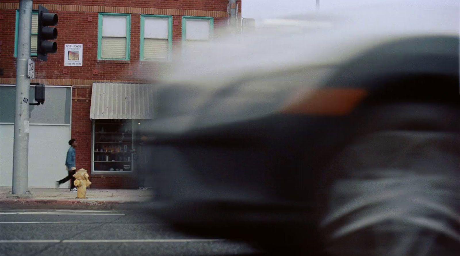 a blurry photo of a person walking down a street