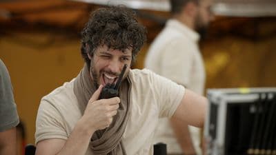 a man holding a cell phone up to his face