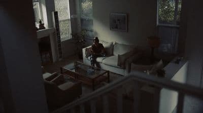a person sitting on a couch in a living room