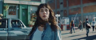 a woman standing in the middle of a street