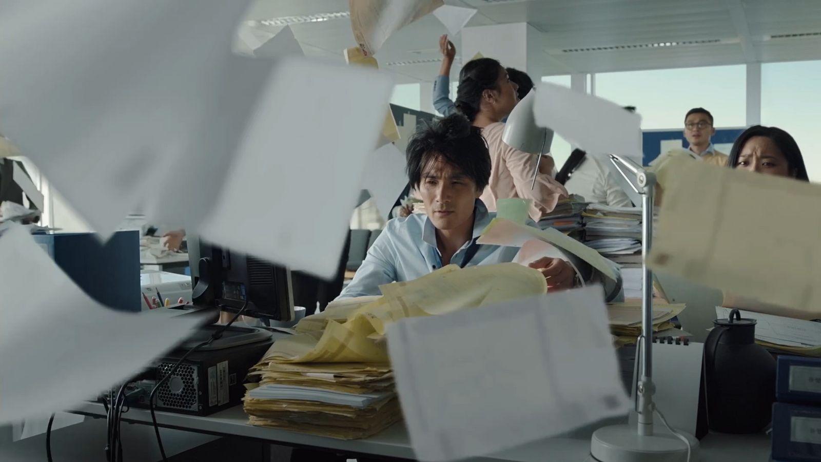 a man sitting at a desk in an office