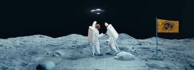 a couple of people standing on top of a snow covered ground