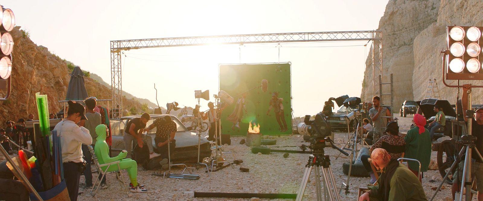 a group of people standing around a camera set up