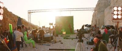 a group of people standing around a camera set up