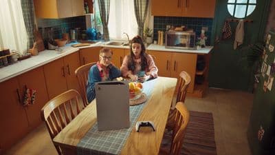 a woman and a child sitting at a kitchen table