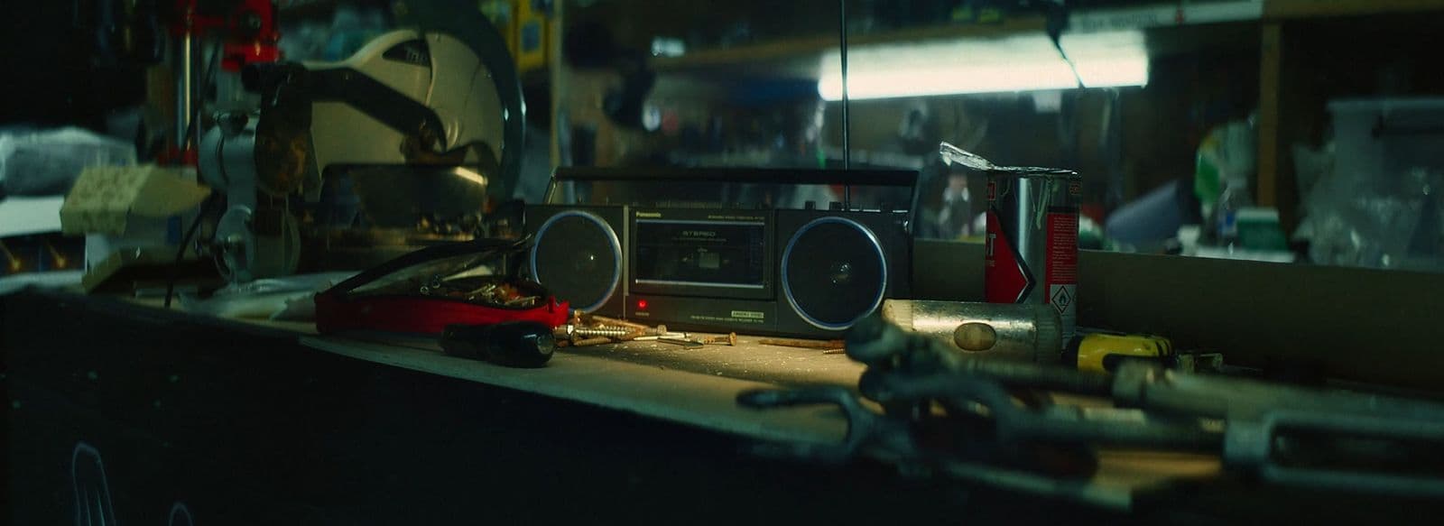 a table topped with a radio next to a pair of wrenches