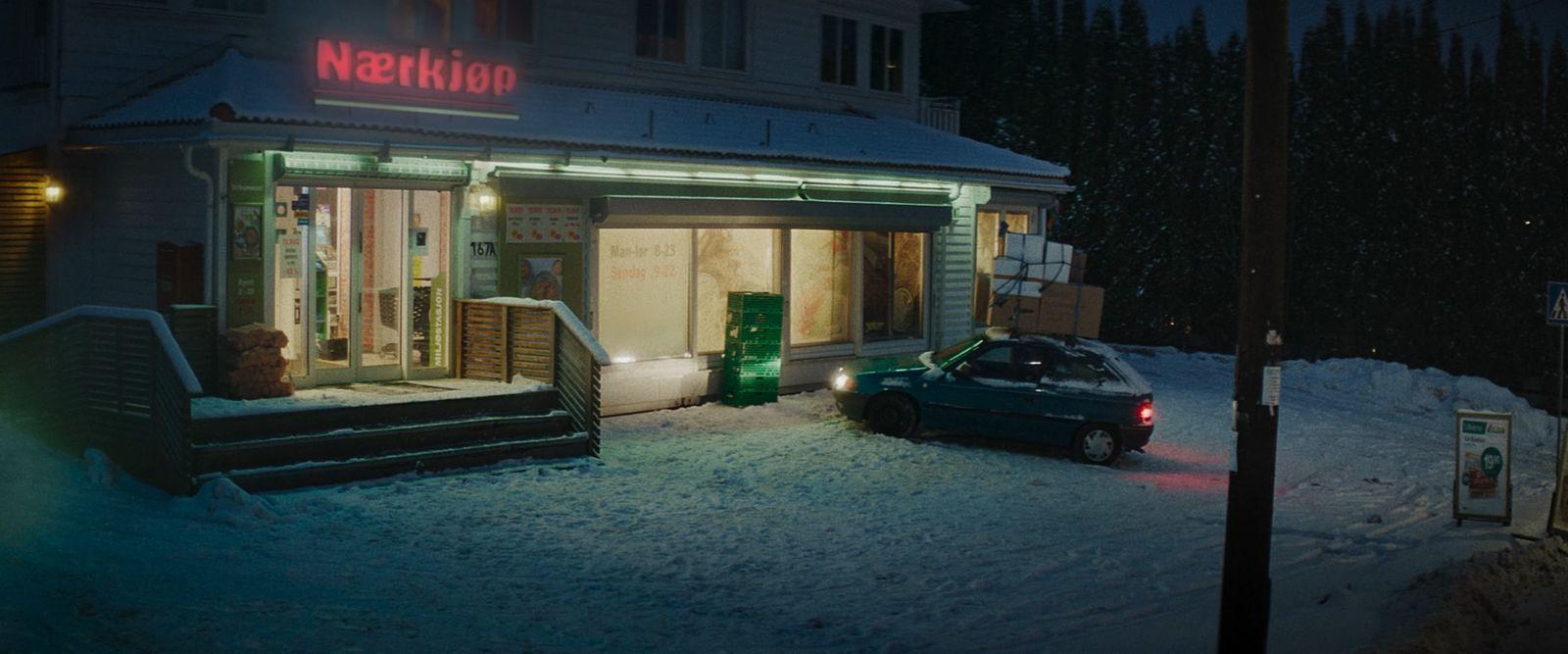 a car parked in front of a building in the snow
