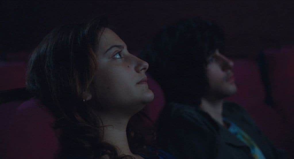a man and a woman sitting in a movie theater