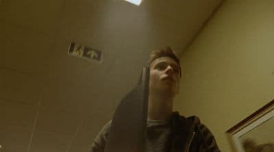 a man standing in front of a mirror in a bathroom