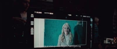 a television screen with a picture of a woman on it