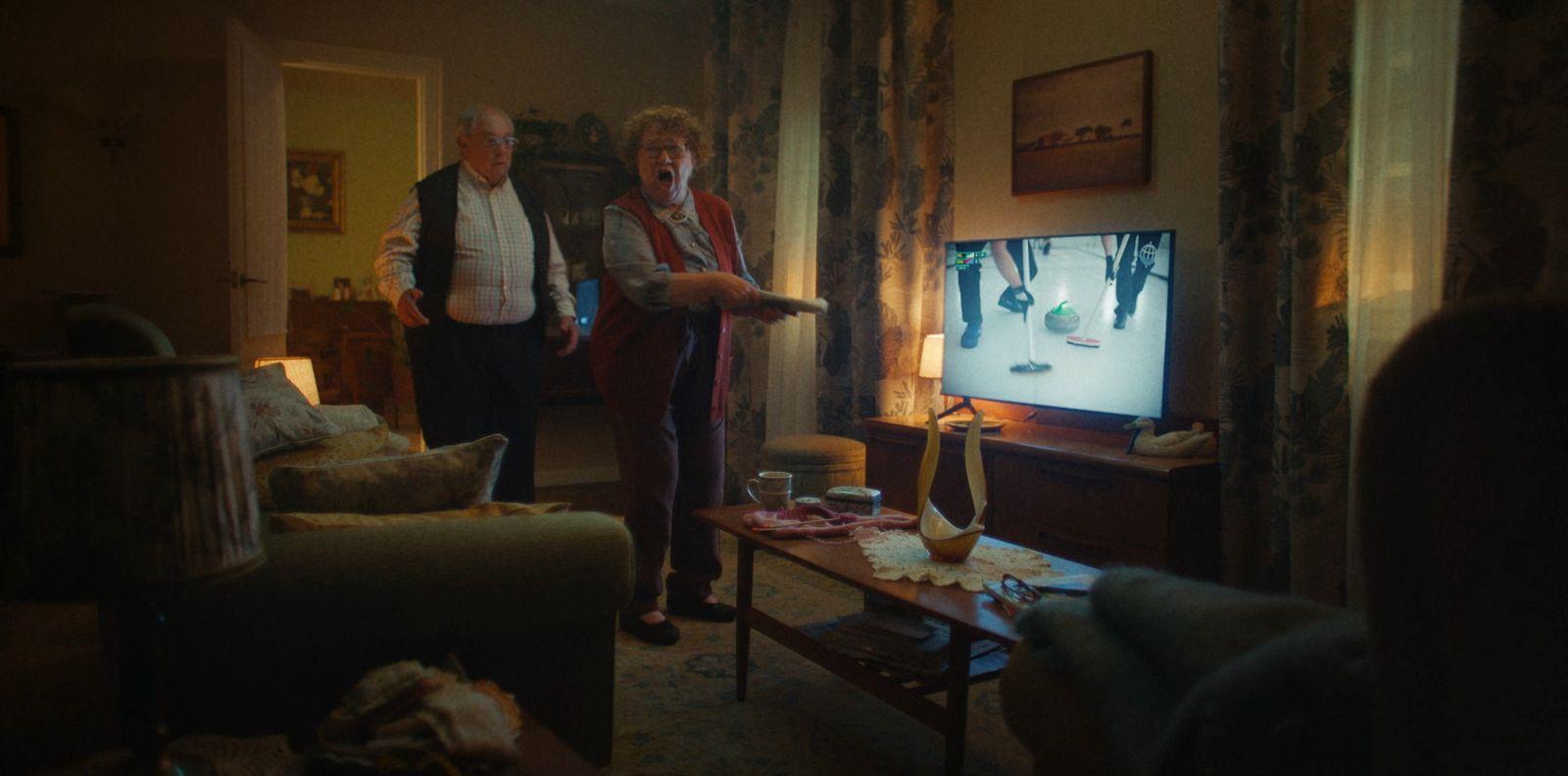 a couple of people standing in a living room