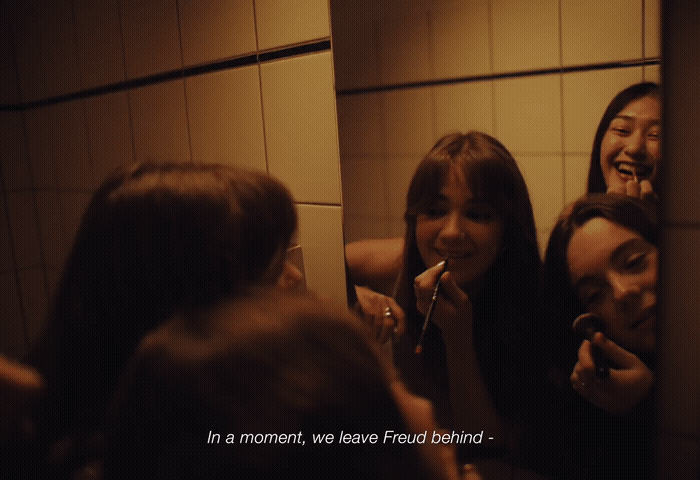 a group of women brushing their teeth in a bathroom