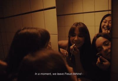 a group of women brushing their teeth in a bathroom