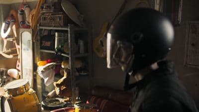 a man in a motorcycle helmet is playing drums