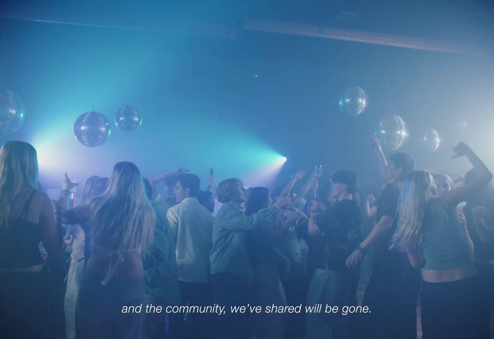 a group of people standing around each other at a party