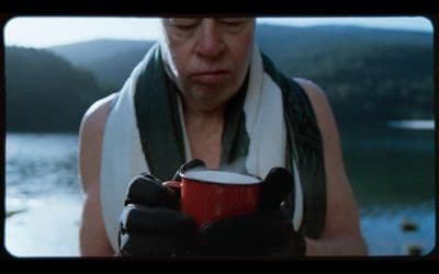 a man holding a cup of coffee in his hands