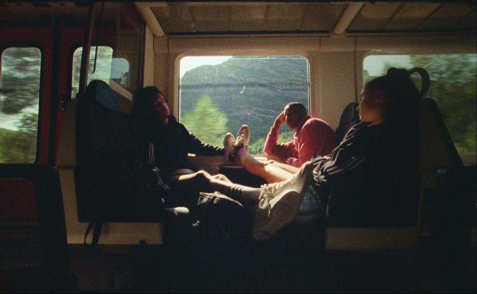 a group of people sitting on top of a train