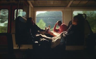 a group of people sitting on top of a train