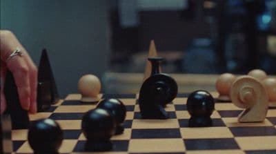 a person playing a game of chess on a chess board