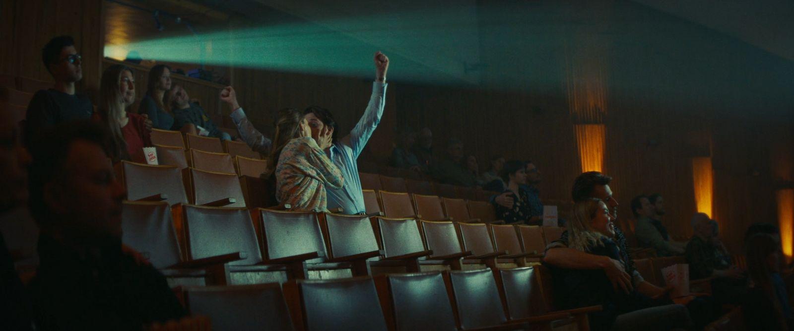 a group of people sitting in a theater