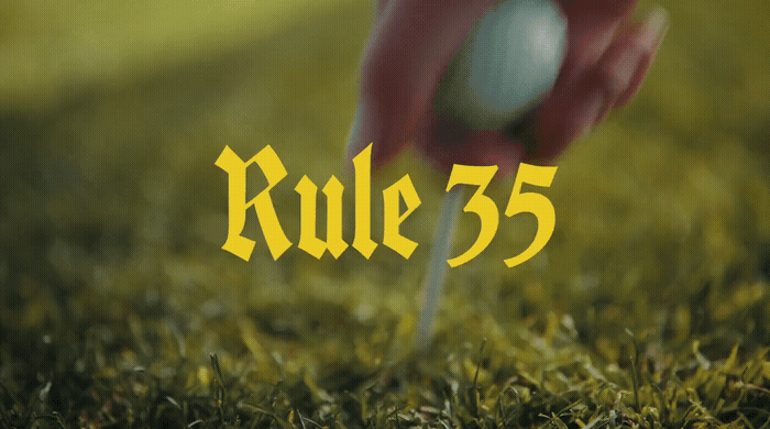 a golf ball being put into a tee