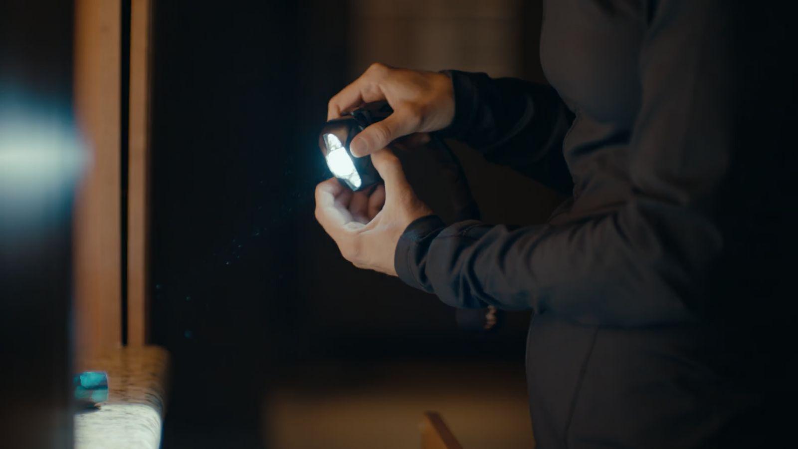 a person holding a cell phone in front of a mirror