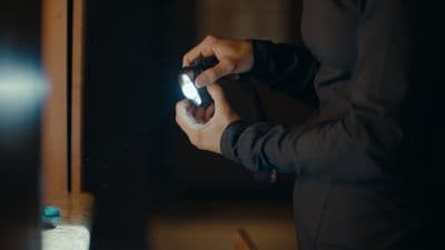 a person holding a cell phone in front of a mirror