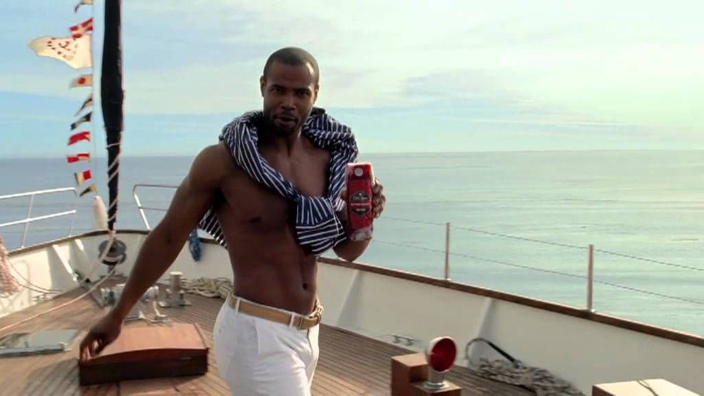 a man standing on a boat holding a cell phone