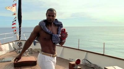 a man standing on a boat holding a cell phone