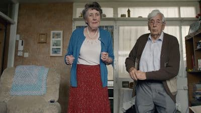 a man and a woman standing in a living room