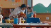 a group of children sitting at desks in a classroom