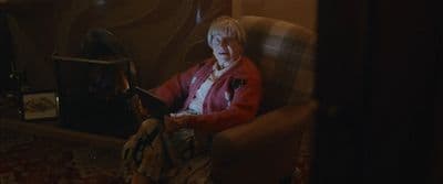 a woman sitting in a chair holding a book