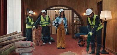 a group of construction workers standing in a room
