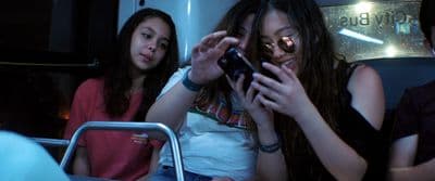 a group of young people sitting next to each other