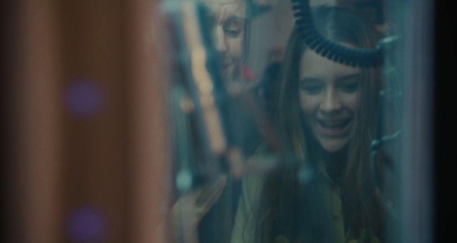 a woman with a blow dryer on her head