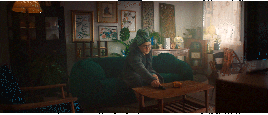 a woman sitting on a green couch in a living room