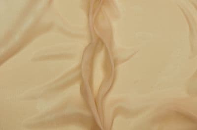 a close up of a bed with a white sheet