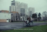 a couple of people sitting on top of a bench