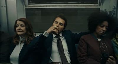 a group of people sitting next to each other on a train