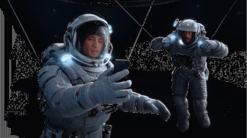 a man in a space suit holding a cell phone