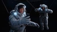 a man in a space suit holding a cell phone