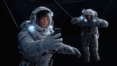 a man in a space suit holding a cell phone