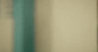 a blurry photo of a wall with a clock on it
