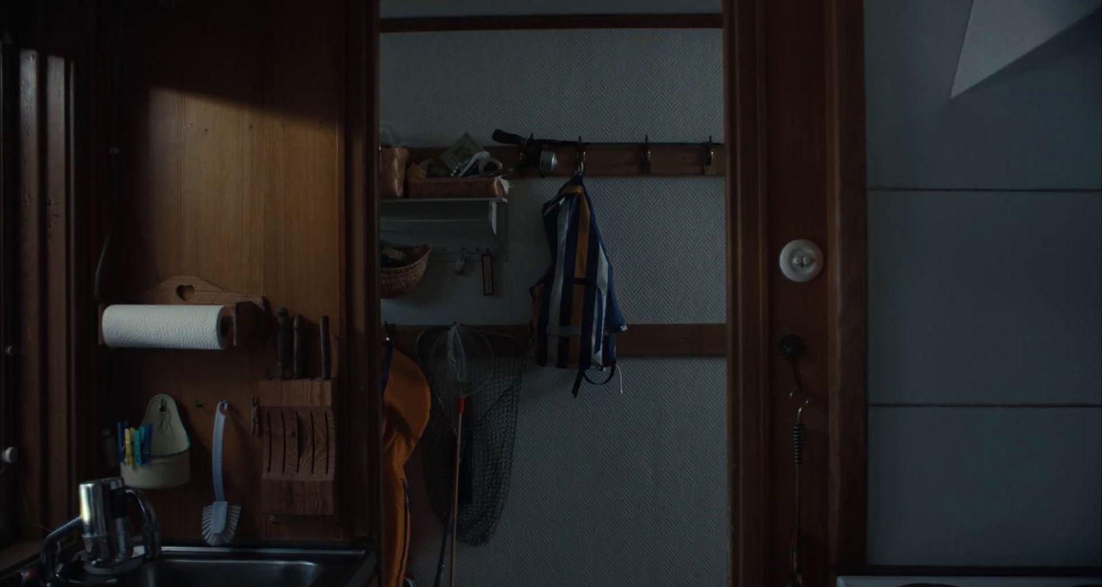 a kitchen with a sink and a wooden door