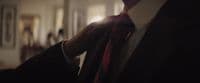 a man in a suit and tie standing in a room