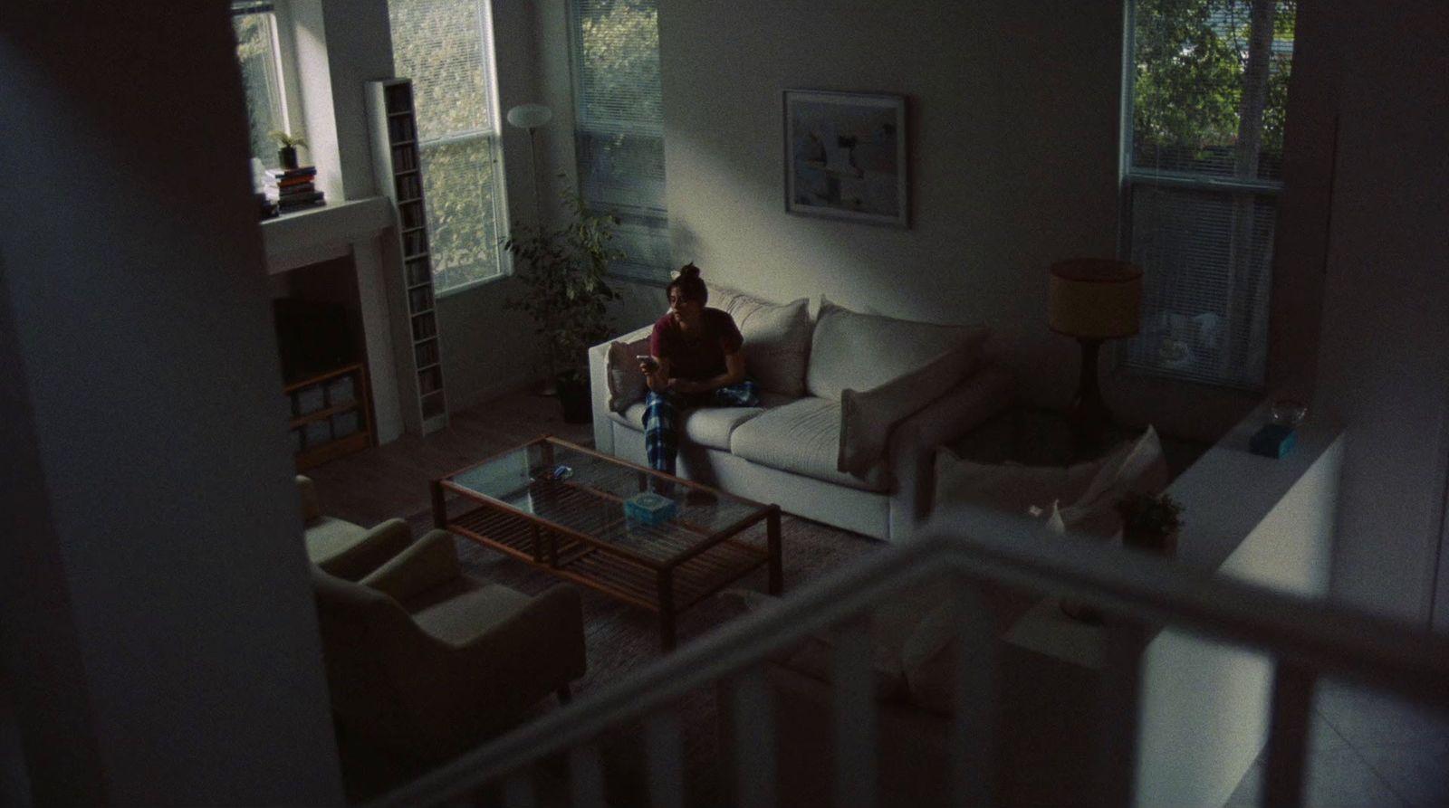 a person sitting on a couch in a living room