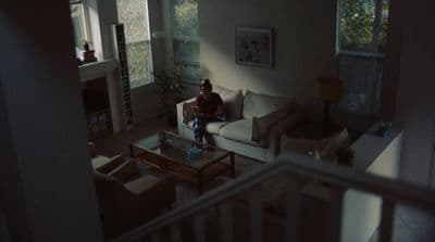 a person sitting on a couch in a living room